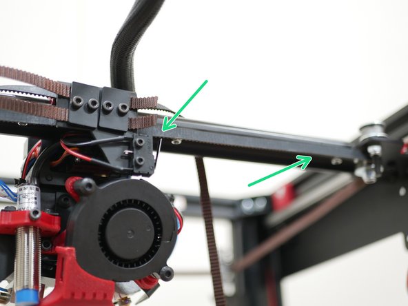 With the rear of the printer facing you take the bottom level belt and loop it around the bearing on the gantry as shown.