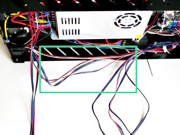 Lay the cables out and cable tie the shorter bunch to the side of the power supply.