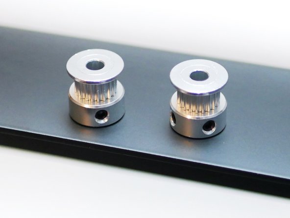 Drop a pulley onto each of the motor shafts.