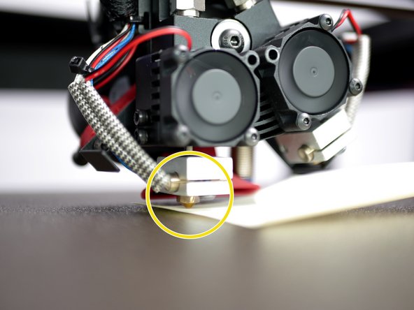 Place a sheet of paper under the nozzle.