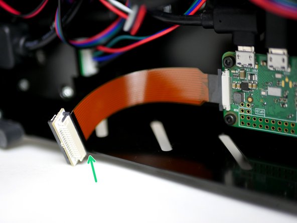 Connect the Pi cam Cable extender to the short golden cable from the Pi Zero W like shown, with the black side facing up.