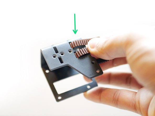 Feed one side of each of the two lengths into the back of the tool carriage as shown.