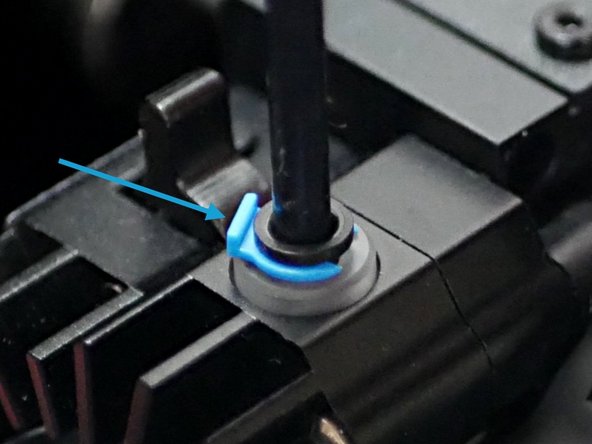 Pull out the blue clip and then push the PTFE tube into the print head. Push the clip back to secure the tube.