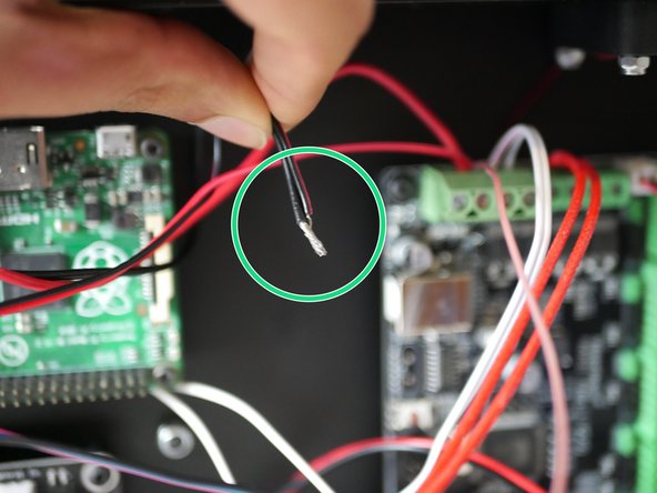 Take the remaining black power cable and black cable form the hotend fan and wind together.