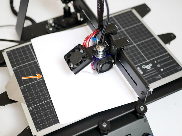 Place a folded piece of paper between the nozzle and print surface. Lower the Z axis in 0.1mm increments until the nozzle grips onto the paper.