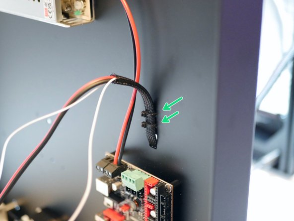 Feed the cables into the hole on the base and secure in place with two cable ties.