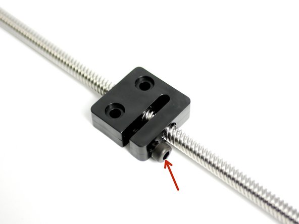 SLOWLY tighten the M5 bolt on the nut to remove any wobble between the nut and leadscrew.