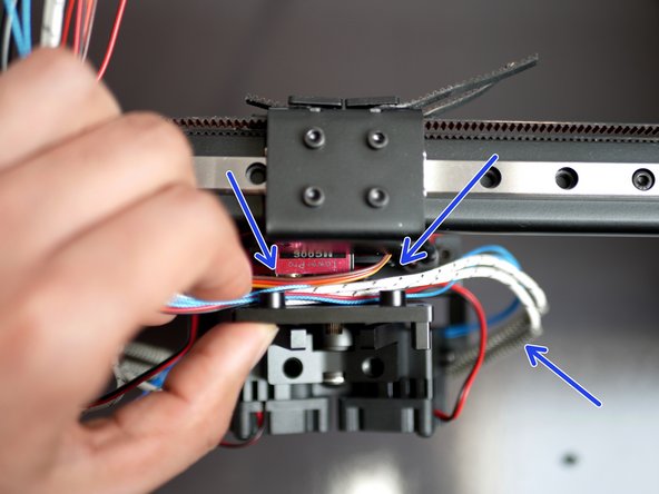 Push the servo into the hole in the tool carriage along with its cable.