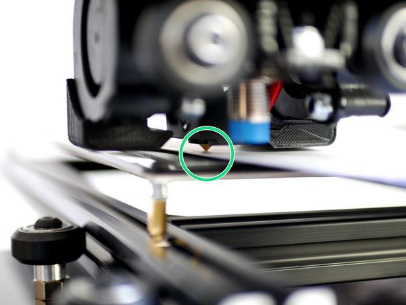 Use a folded piece of paper to feel the gap between the nozzle and print surface.