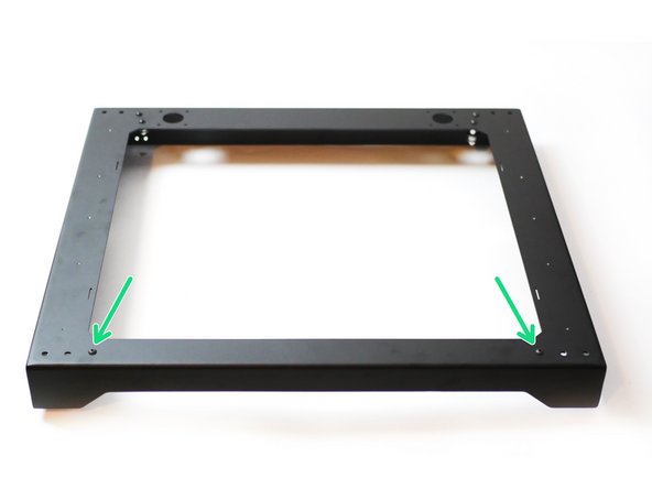 Install the two idler assemblies onto the front of the top panel as shown.