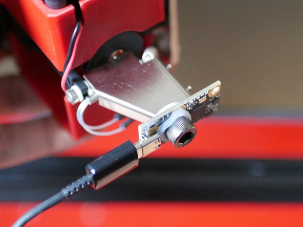 Use the Mainsail web interface or the touch screen to move the print head to roughly the centre and lower the print bed. Unscrew the nozzle and fix in its place the S2DW board using the included hardware.