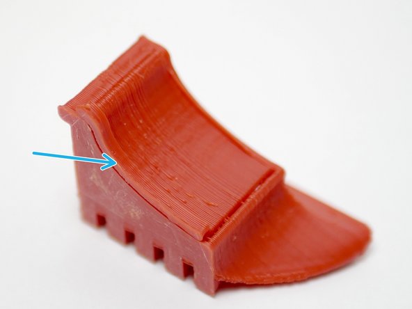 The part cooling fan shroud is a 3D-printed ABS part. Begin by removing the support with a pair of pliers by pulling on the tab.