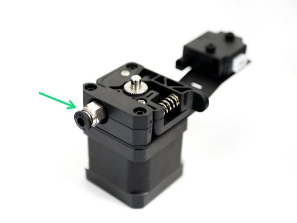 Fix the pneumatic coupling onto the extruder assembly.