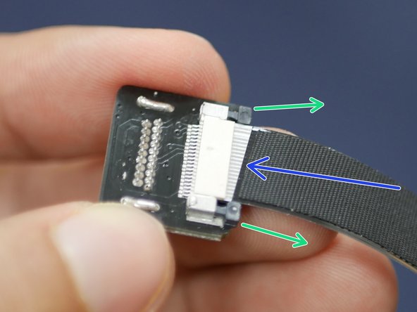 Do this by carefully pulling the black tabs here out.