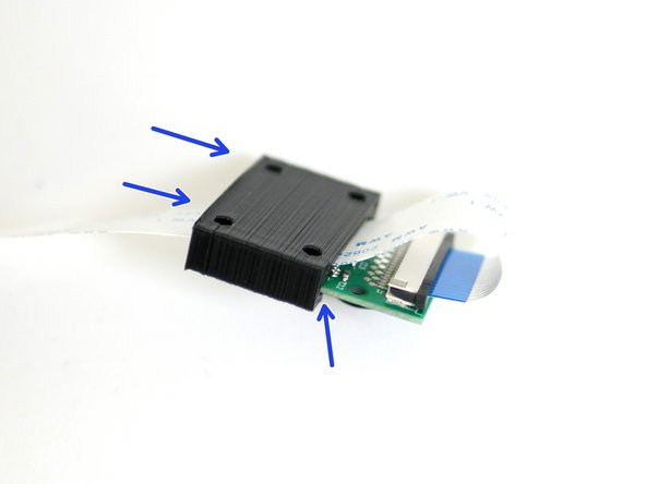 Slide the 3D Printed cover onto the Pi Cam with the ribbon cable looped over and sandwiched between them.