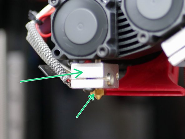 Hold the heater block with one set of pliers and tighten the nozzle down with the other set.