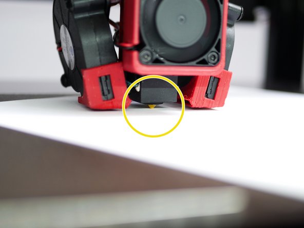 Place a sheet of paper under the nozzle.