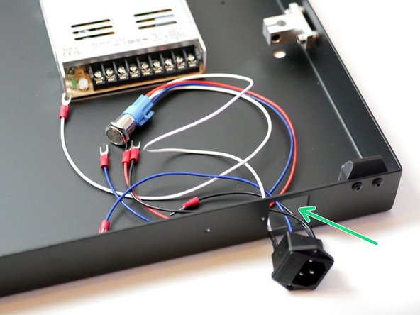 Push the switch side of the assembly in through the rectangular cut-out at the back of the base.