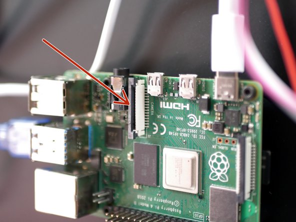 Pull up on the tab on the Pi board.