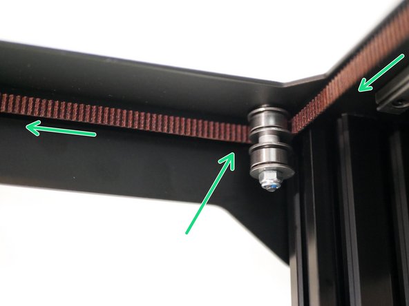 Whilst keeping some tension on the belt to prevent it from falling off the idlers, pull it forward and wrap it around the front idlers like shown.