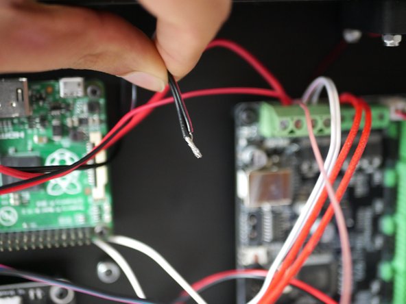 Take the remaining black power cable and black cable form the hotend fan and wind together.