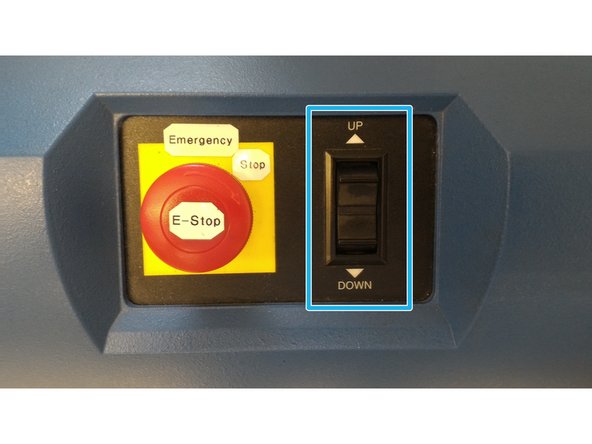 Use the control panel on the front of the machine to adjust the crosshead distance. The jaws should be close enough to grip each end of the sample.