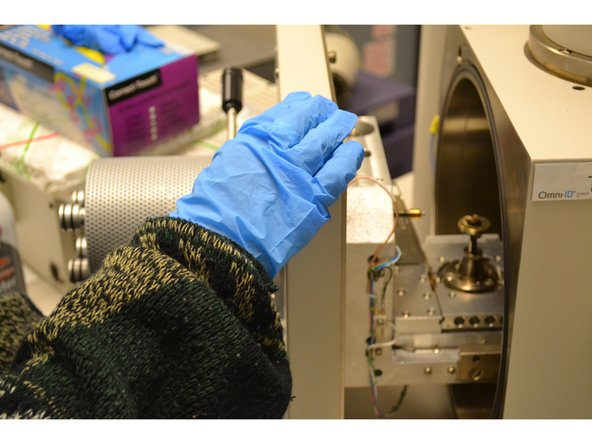 Watch the video screen and slowly close the SEM door by its handle while wearing gloves.