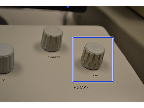 Focus the sample using the  Fine focus knob on the front right of the console.