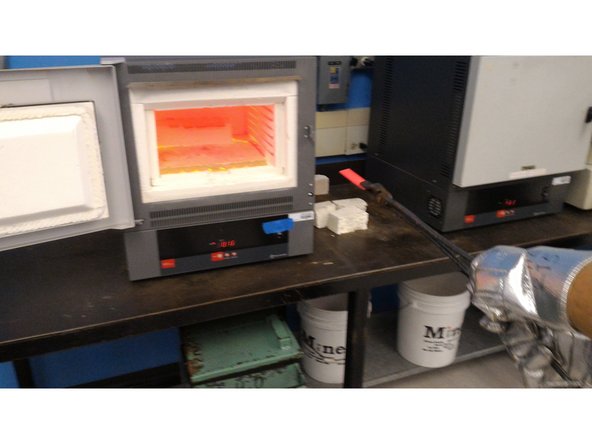 Operator B : While wearing the proper safety gear, use the tongs to grab the workpiece.