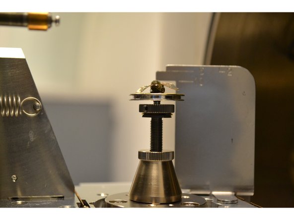 The height of your sample can be adjusted by rotating the sample stage by hand (wearing gloves). A clockwise rotation will move your sample up, while a counter-clockwise rotation will move your sample down.