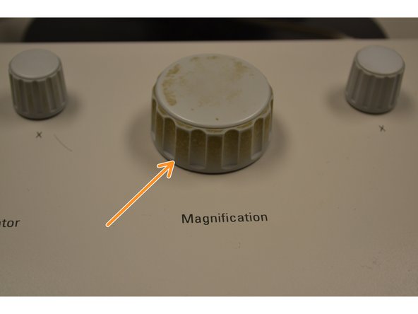 Zoom out of the image by turning the magnification knob counterclockwise.