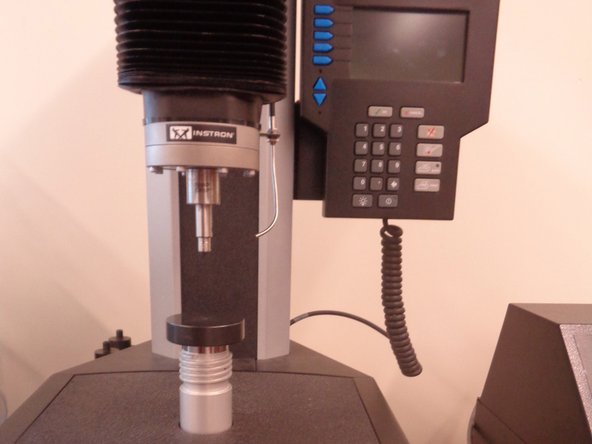 Retract the indenter using the up arrow in front of the machine