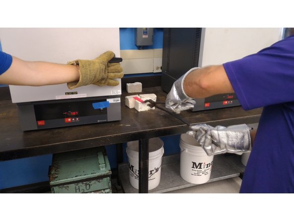 Remove the workpiece from the oven, placing it on the provided white alumina blocks.