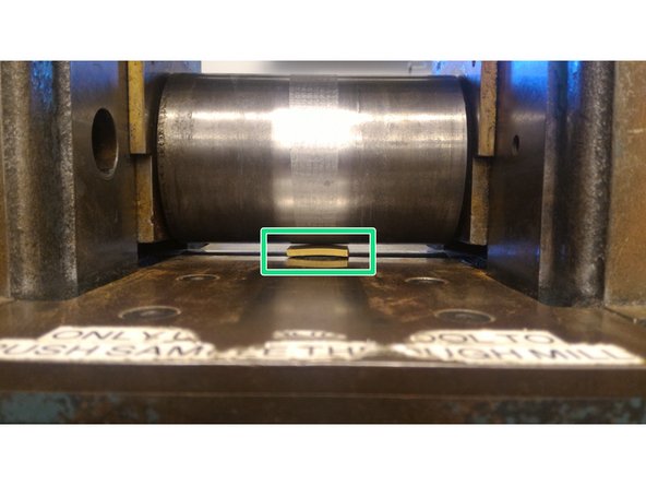 This step requires reaching into the machine. Do not allow anyone to go near the control panel. Be ready to press the emergency stop lever with your legs in case of an accidental startup.