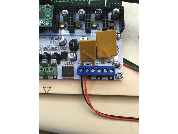 Insert wires from 12v power connector into terminal blocks ensuring that the red wire is inserted into the positive terminal and the black wire is inserted into the negative block