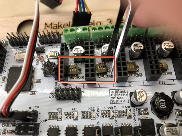 Using a tool with a fine tip, press the dip switches from north (default) to south.