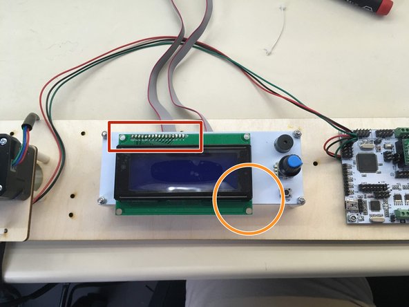 the green part of the screen is attached to the white part only here.  When the motors turn vibration is picked up by these two parts and they buzz against each other.