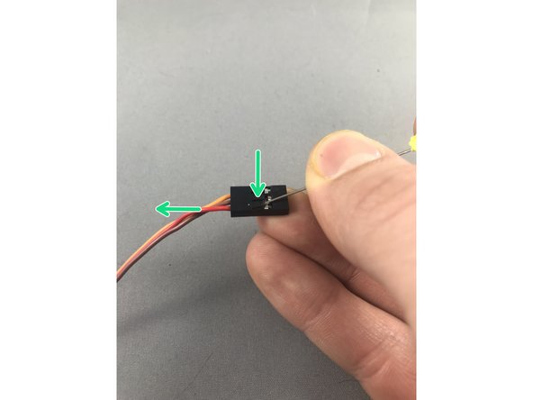 While gently pulling on the red wire, slide a pin under the hook of the black JST header to carefully lift and release the crimp pin.  When you get it right the crimp pin will slide out effortlessly.  Lifting too hard can break the hook so be gentle!
