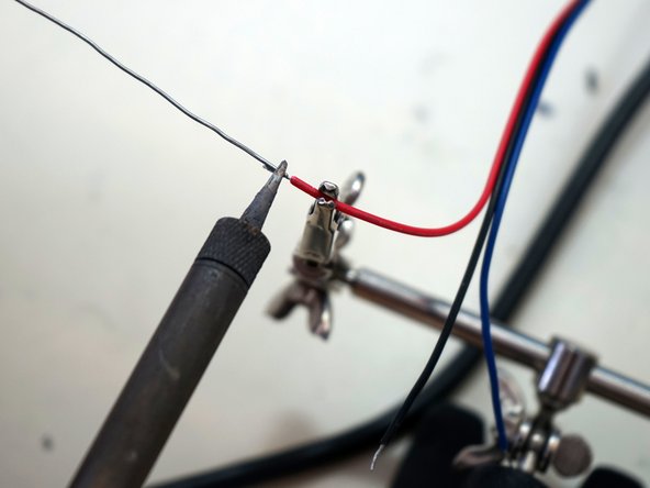 Twist the jacket with the other hand.  The wires will twist around each other to form a compact spiral.