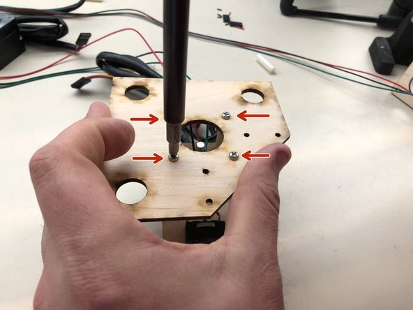 Carefully turn the assembly over and then tighten the four screws into the motor.