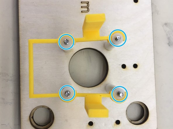 Slide four 25 mm spacers onto the screws and clip on motor bracket