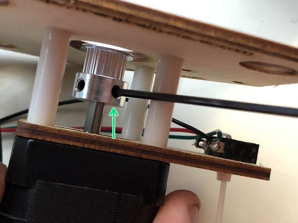 Use a size 2 metric alan key to tighten the set screw against the flat side of the motor shaft.