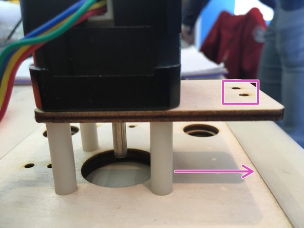 Slide four 25 mm spacers onto the screws and clip on motor bracket
