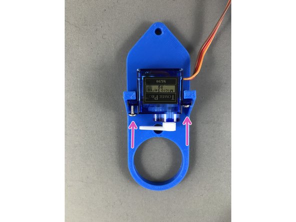 Position the servo as it is in the picture and insert 2 screws and tighten them snug.