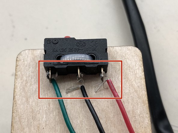Using the iron to melt the solder on both the switch leg and the wire, fuse them together.  remove the iron and wait a moment for the solder to cool. This is an example of a good solder.