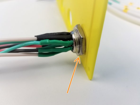 Feed the Cables through the Wall Adapter as labelled.   Make sure the long end of the cable ends up on the back side of the panel.