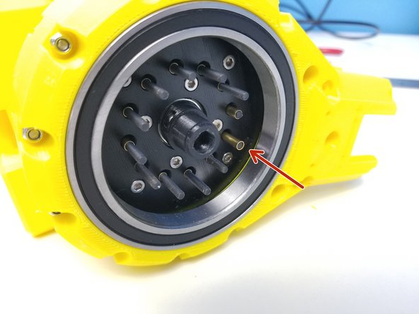 While keeping the Gearbox on its side, insert 3.5x18.5mm Brass Tubes on each Screws