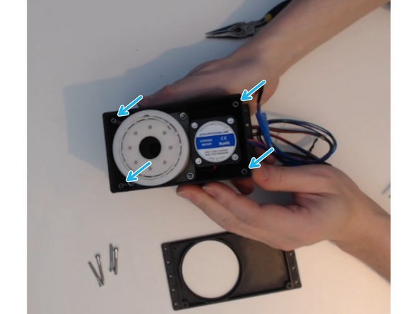 There is a slot in each corner of the core made to fit a spacer.  The screw helps hold the spacer in place.
