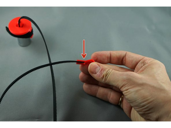 Press the other end of the belt into the hook.