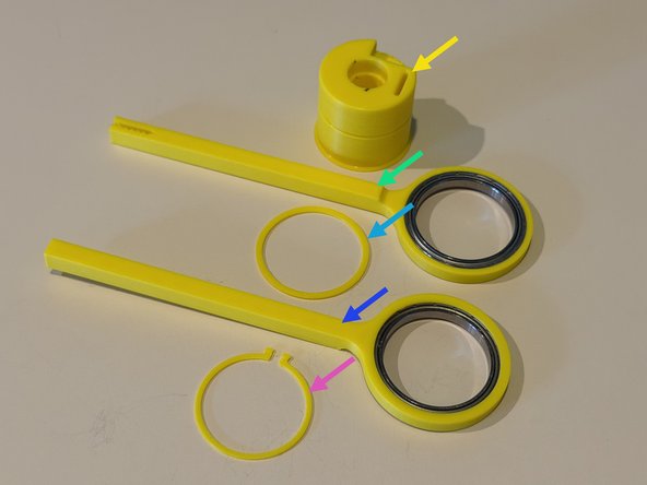 Locate the bearings.  They are identical.  One bearing should be pressed into each arm.